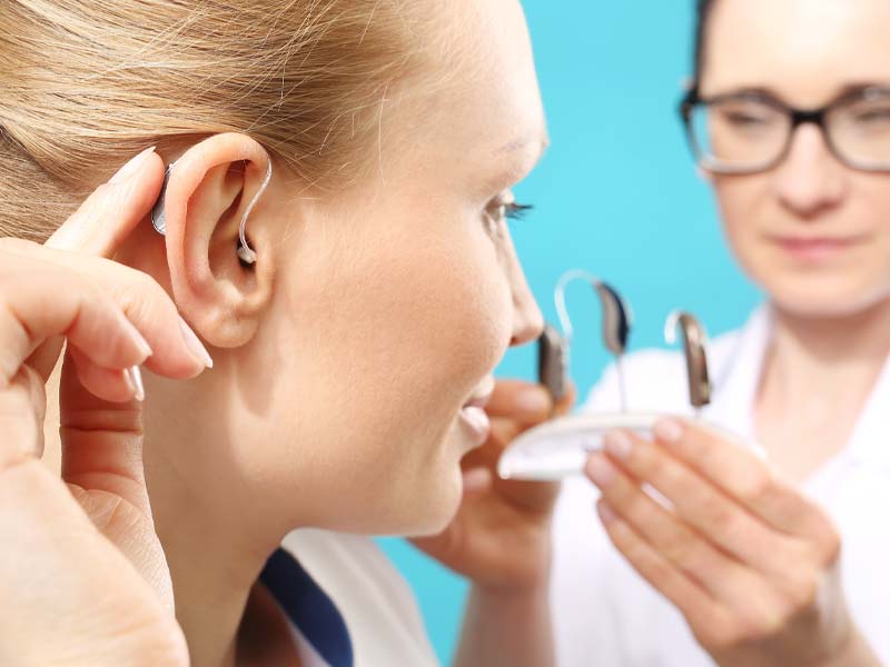 Woman trying on hearing aids