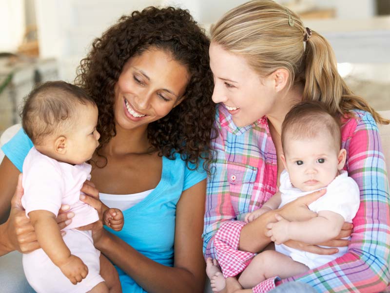 Two woman enjoying their babies