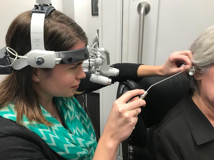 Audiologist testing a patient's hearing