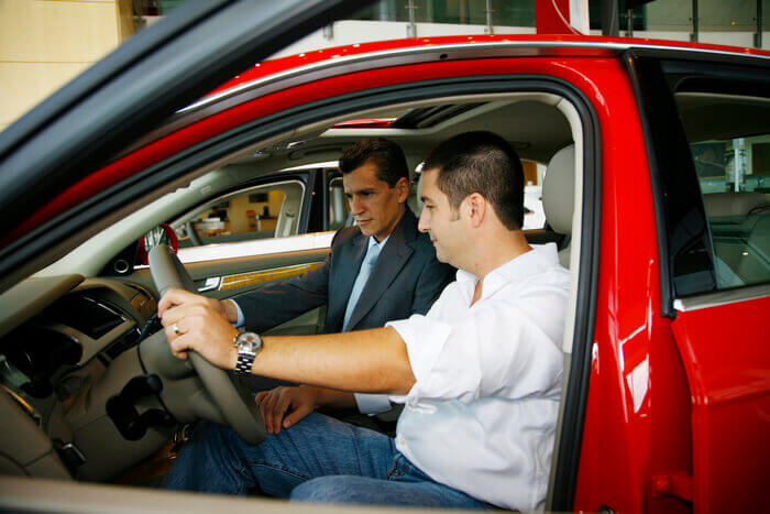 Men in a car reviewing airbags and the effects on hearing