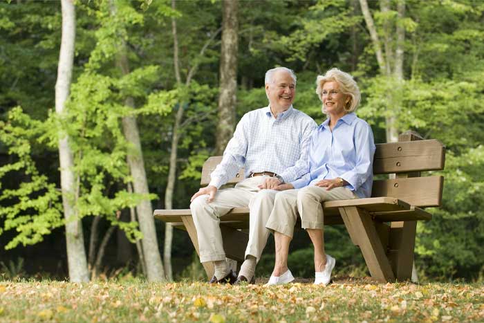 Older couple bird watching in the park.